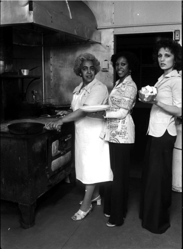 Adelene Ellen Alexander Clark and her daughter Vie Clark in the kitchen of Vie's Chicken and Steak House, 209 Union Street, November 1976