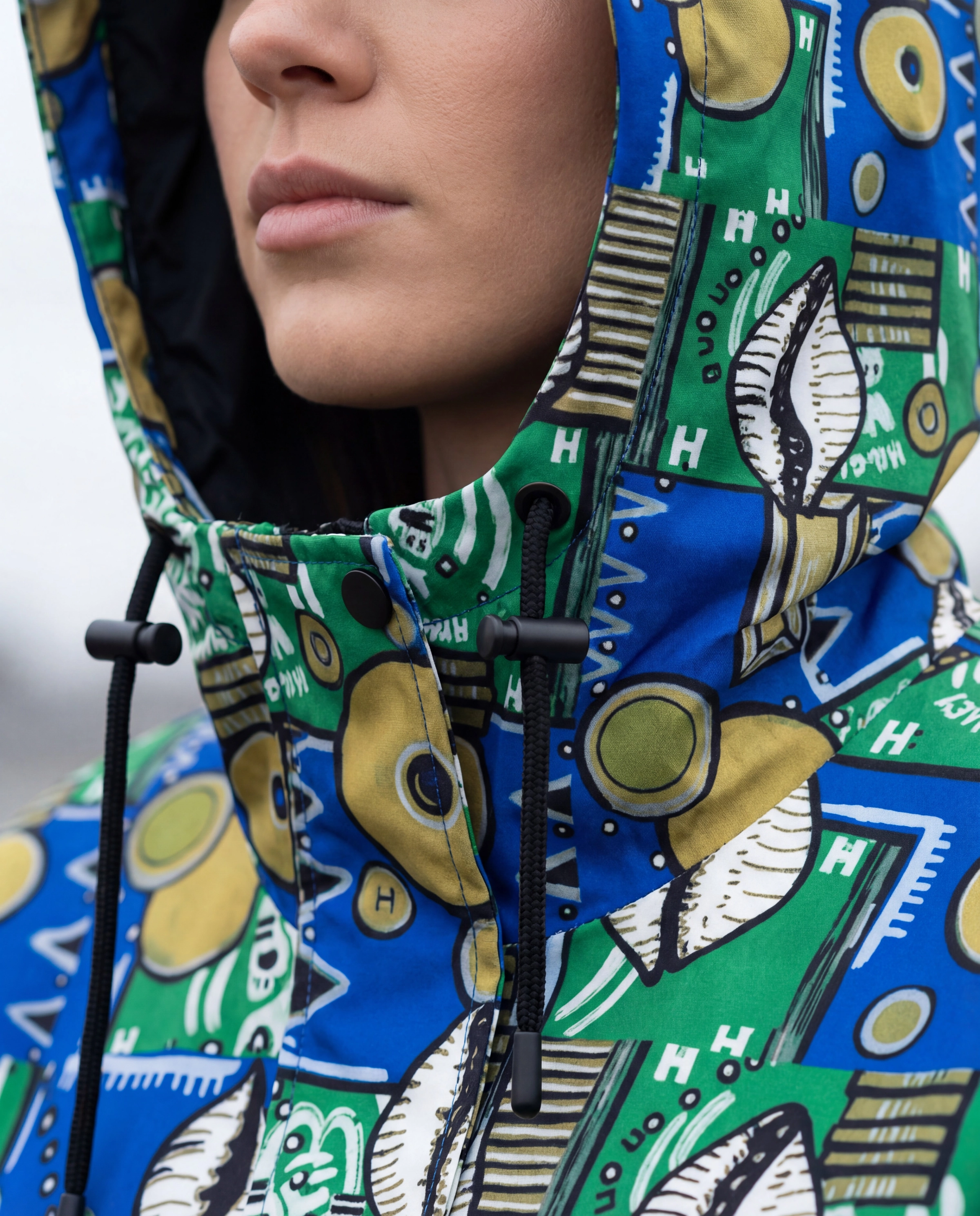 Hood with three-point drawcord system